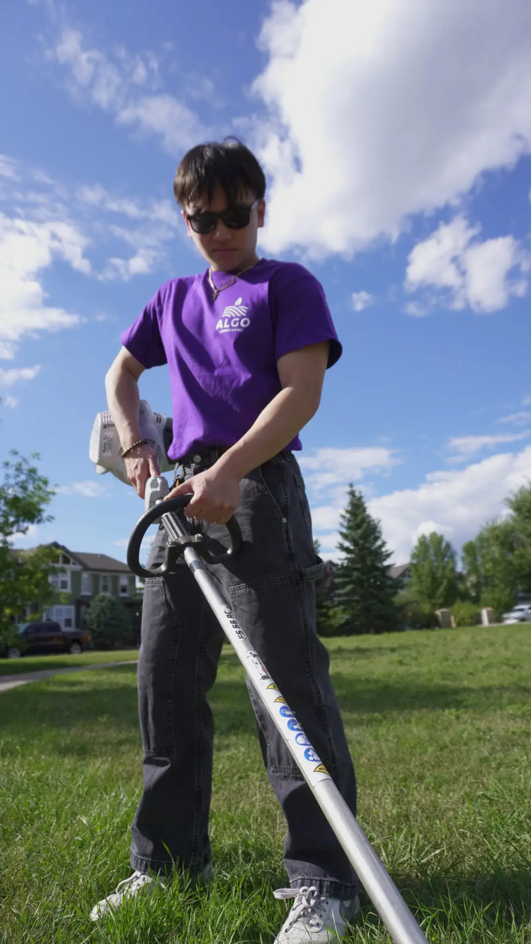 Algo Crew Member using weed whacker to maintain property professionally