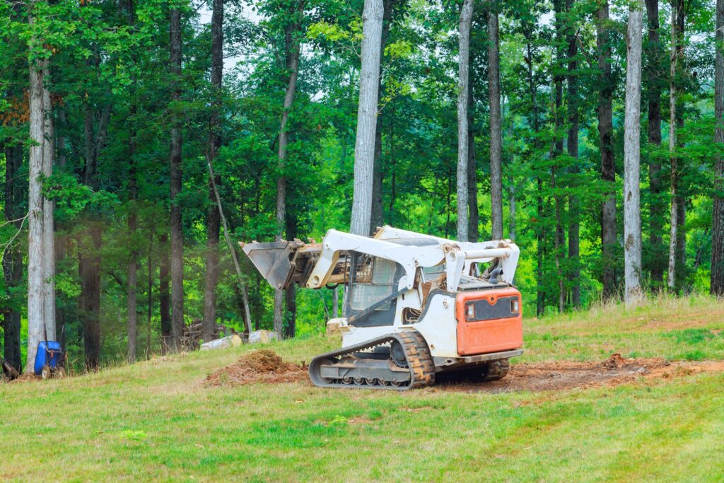 Ground is moved in a bulldozer while landscaping work is being performed