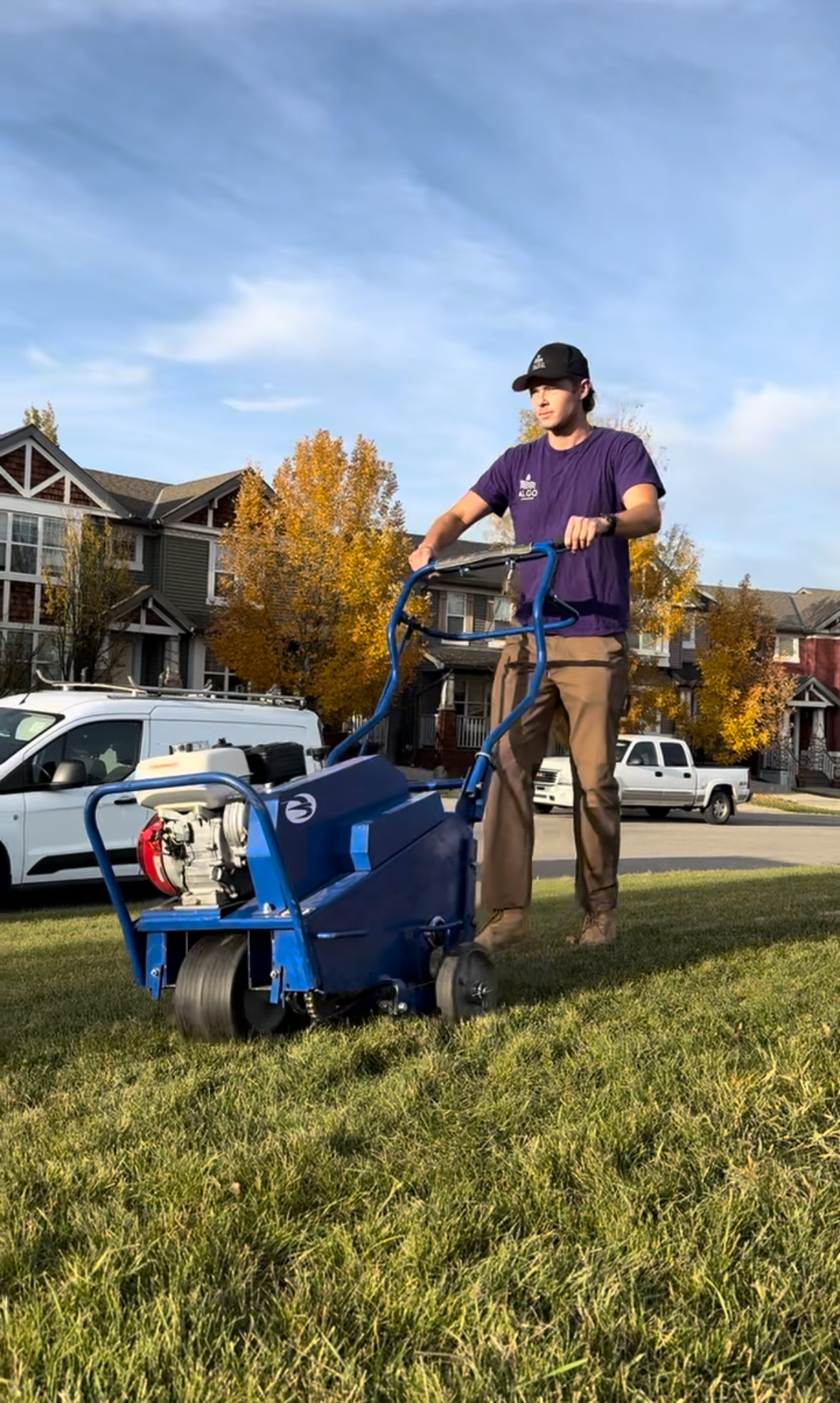 Algo Landscaping owner performing lawn aeration service in Calgary using core aeration machine